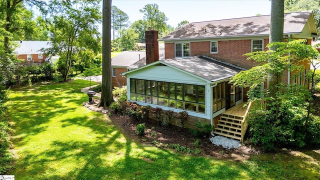 302 Spruce St, Clinton, SC 29325 - rear view of property with a sunroom, a chimney, a shingled roof, a yard, and stairway