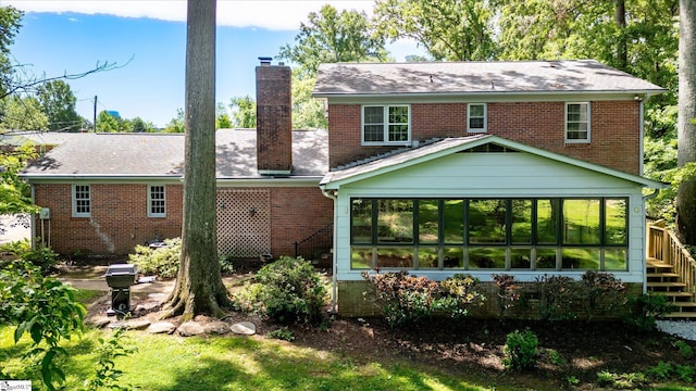 302 Spruce St, Clinton, SC 29325 - back of property with a chimney, a sunroom, and brick siding