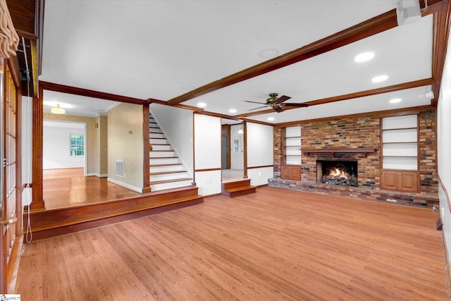 302 Spruce St, Clinton, SC 29325 - unfurnished living room featuring crown molding, light wood-style flooring, a ceiling fan, a brick fireplace, and baseboards