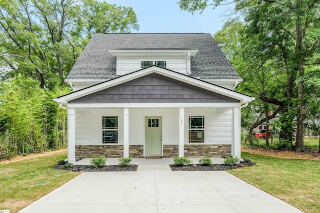 101 Poplar Ave, Belton, SC 29627 - view of front of property featuring covered porch, a front yard, roof with shingles, and stone siding