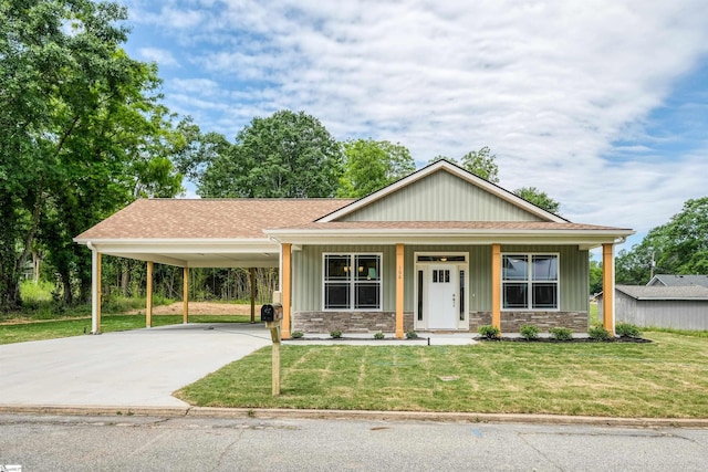 106 N St, Belton, SC 29627 - view of front facade with a carport, a front yard, a shingled roof, concrete driveway, and covered porch