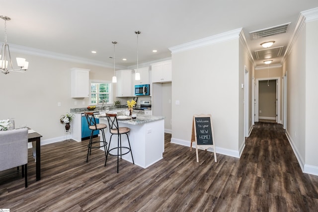 106 N St, Belton, SC 29627 - kitchen with stainless steel microwave, a kitchen island, dark wood-style floors, white cabinetry, and baseboards
