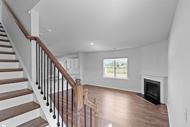 1072 Longstone Way, Spartanburg, SC 29306 - staircase with wood finished floors, a fireplace with flush hearth, baseboards, and recessed lighting