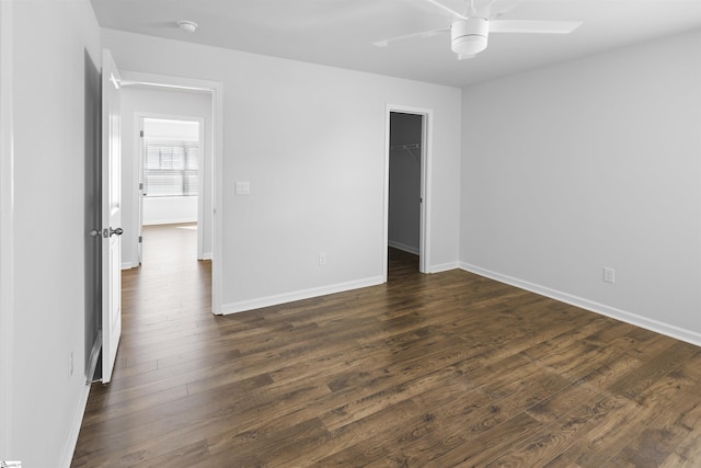 1072 Longstone Way, Spartanburg, SC 29306 - unfurnished bedroom featuring dark wood-style flooring, baseboards, ceiling fan, a walk in closet, and a closet