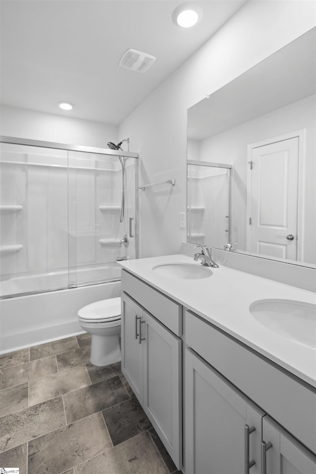 1072 Longstone Way, Spartanburg, SC 29306 - full bath with double vanity, toilet, enclosed tub / shower combo, stone finish flooring, and recessed lighting