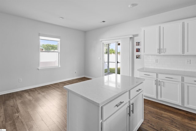 1072 Longstone Way, Spartanburg, SC 29306 - kitchen featuring dark wood-type flooring, tasteful backsplash, light stone countertops, and a kitchen island