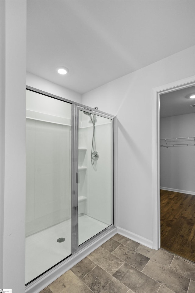 1072 Longstone Way, Spartanburg, SC 29306 - full bathroom featuring a stall shower, a walk in closet, baseboards, and stone finish flooring