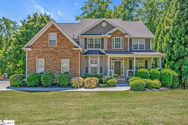 67 Devonhall Way, Taylors, SC 29687 - craftsman house with stone siding, a front yard, a porch, and roof with shingles
