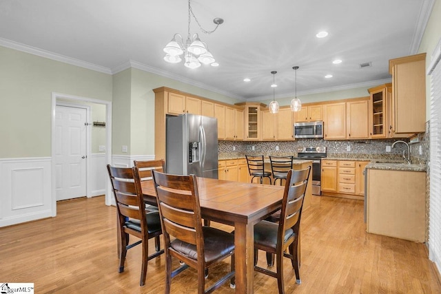 67 Devonhall Way, Taylors, SC 29687 - dining space with light wood finished floors, a chandelier, recessed lighting, crown molding, and wainscoting