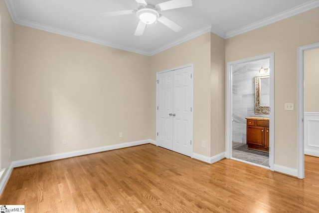 67 Devonhall Way, Taylors, SC 29687 - unfurnished bedroom with light wood finished floors, crown molding, a closet, baseboards, and connected bathroom