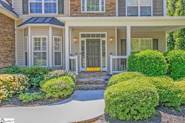 67 Devonhall Way, Taylors, SC 29687 - view of exterior entry featuring a porch, a standing seam roof, and stone siding