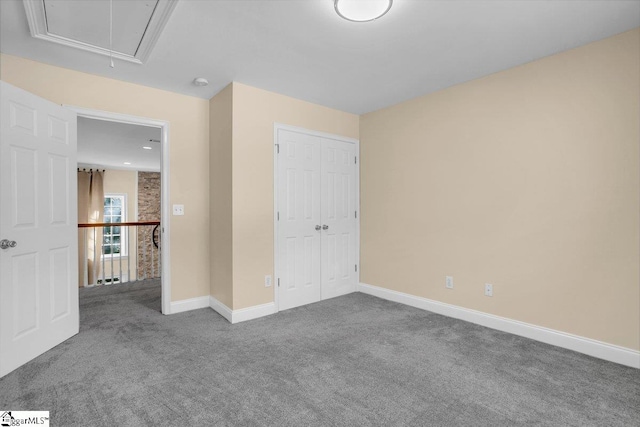 67 Devonhall Way, Taylors, SC 29687 - unfurnished bedroom with attic access, carpet flooring, baseboards, and a closet