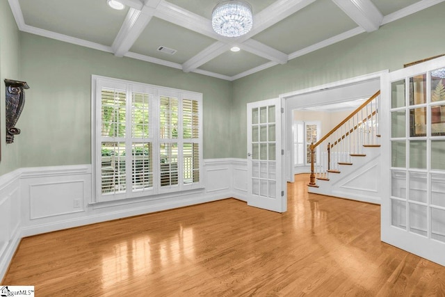 67 Devonhall Way, Taylors, SC 29687 - empty room featuring french doors, coffered ceiling, beam ceiling, a chandelier, and wood finished floors