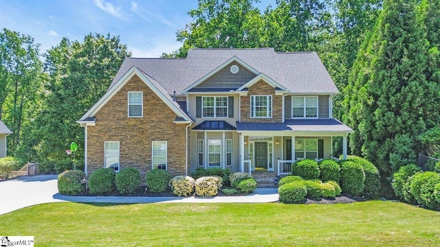 67 Devonhall Way, Taylors, SC 29687 - craftsman-style home with stone siding, covered porch, and a front lawn