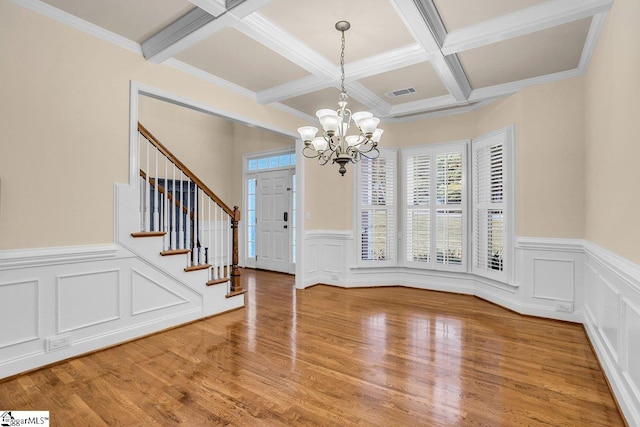 67 Devonhall Way, Taylors, SC 29687 - entrance foyer with a chandelier, beam ceiling, wainscoting, coffered ceiling, and a decorative wall