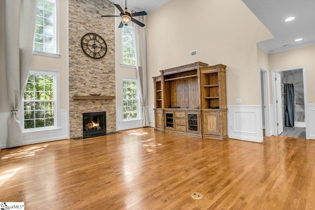 67 Devonhall Way, Taylors, SC 29687 - unfurnished living room with a high ceiling, a fireplace, ceiling fan, wood finished floors, and wainscoting