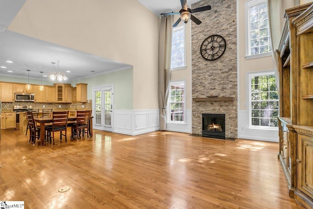 67 Devonhall Way, Taylors, SC 29687 - living area featuring ornamental molding, ceiling fan, a fireplace, light wood-style flooring, and a high ceiling