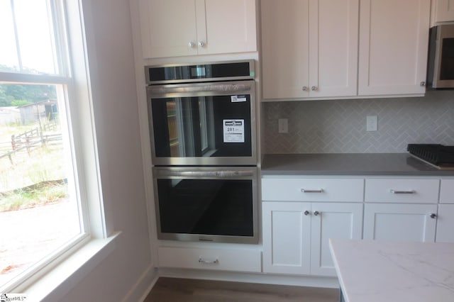 3140 Midway Rd Lot 97, Anderson, SC 29621 - kitchen with appliances with stainless steel finishes, white cabinetry, backsplash, and wood finished floors