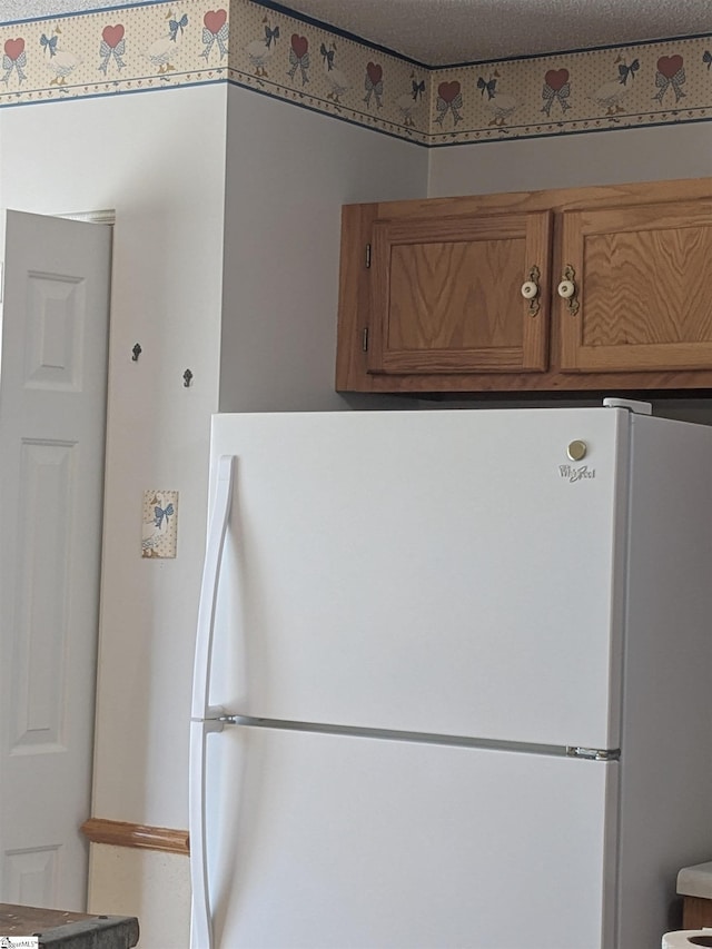 7 Willow Wood Ct, Taylors, SC 29687 - kitchen featuring freestanding refrigerator and brown cabinetry