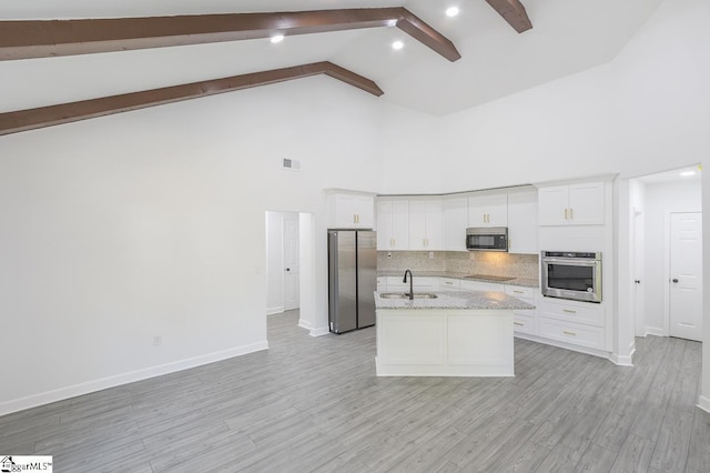 1008 Tribble St, Anderson, SC 29625 - kitchen featuring appliances with stainless steel finishes, high vaulted ceiling, beamed ceiling, baseboards, and decorative backsplash