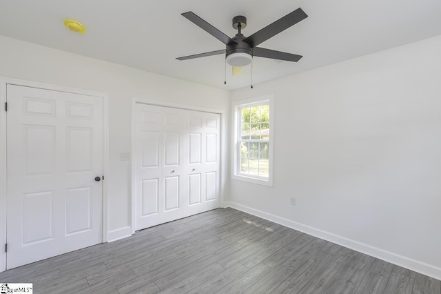 1008 Tribble St, Anderson, SC 29625 - unfurnished bedroom with baseboards, wood finished floors, a closet, and ceiling fan