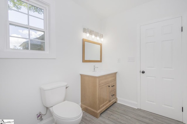 1008 Tribble St, Anderson, SC 29625 - half bath featuring vanity, baseboards, toilet, and wood finished floors