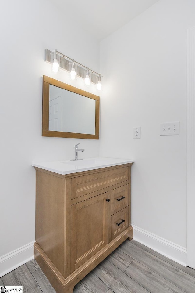 1008 Tribble St, Anderson, SC 29625 - bathroom with baseboards, vanity, and wood finished floors