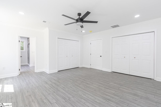 1008 Tribble St, Anderson, SC 29625 - unfurnished bedroom featuring crown molding, multiple closets, baseboards, recessed lighting, and light wood-type flooring