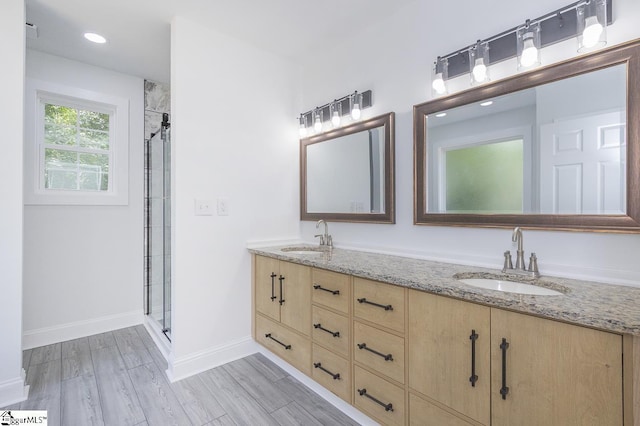 1008 Tribble St, Anderson, SC 29625 - full bath featuring double vanity, a shower stall, baseboards, wood finished floors, and recessed lighting