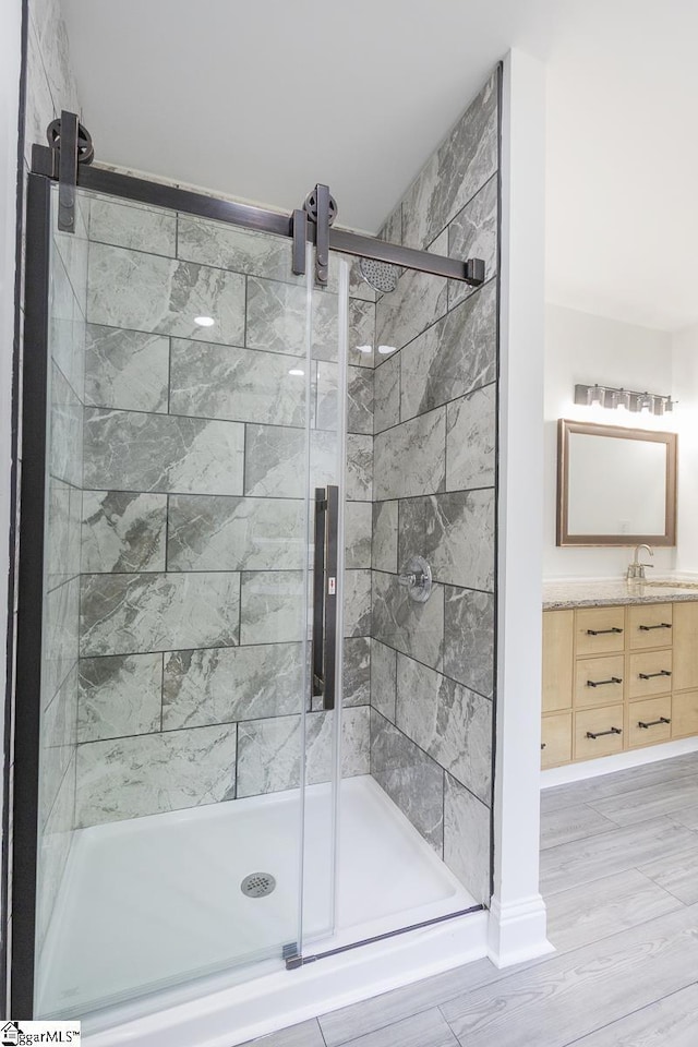 1008 Tribble St, Anderson, SC 29625 - full bathroom featuring a shower stall, vanity, and wood finished floors