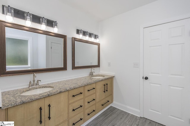 1008 Tribble St, Anderson, SC 29625 - full bath with double vanity, wood finished floors, and baseboards