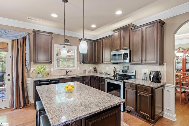 100 Claiborne Rd, Piedmont, SC 29673 - kitchen featuring stainless steel appliances, dark brown cabinets, crown molding, a sink, and arched walkways