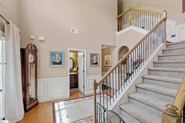 100 Claiborne Rd, Piedmont, SC 29673 - entryway featuring stairway, wood finished floors, a wainscoted wall, and a towering ceiling