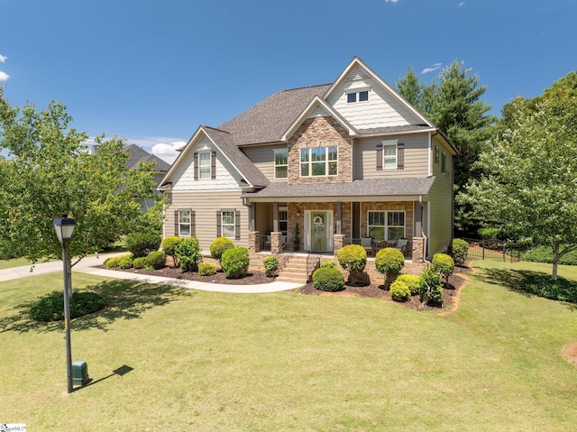 100 Claiborne Rd, Piedmont, SC 29673 - craftsman-style home featuring stone siding, a porch, a front yard, and roof with shingles