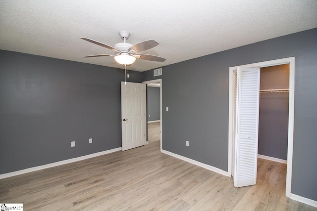 1507 Northlake Dr, Anderson, SC 29625 - unfurnished bedroom with light wood finished floors, a closet, baseboards, a ceiling fan, and a textured ceiling