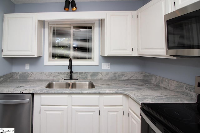 1507 Northlake Dr, Anderson, SC 29625 - kitchen featuring stainless steel appliances, a sink, white cabinetry, and light stone counters