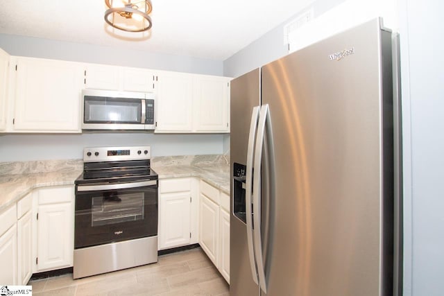 1507 Northlake Dr, Anderson, SC 29625 - kitchen with appliances with stainless steel finishes, light wood-type flooring, and white cabinets