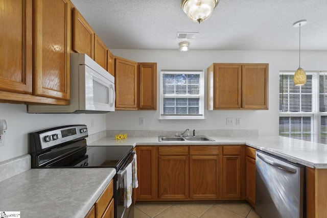 103 Berry Ct, Belton, SC 29627 - kitchen featuring stainless steel appliances, a sink, a peninsula, light countertops, and brown cabinetry