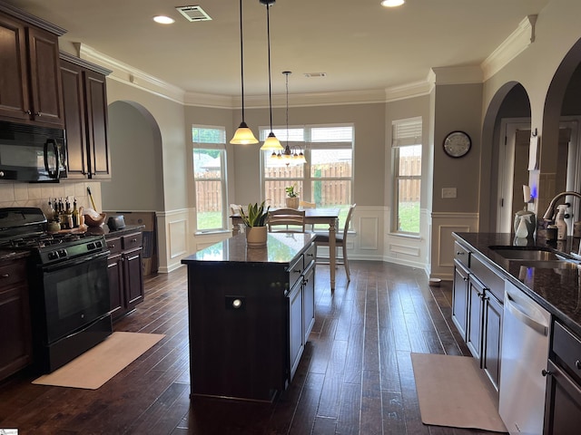 112 Cameron Creek Ln, Simpsonville, SC 29681 - kitchen with black appliances, arched walkways, a sink, a decorative wall, and a kitchen island
