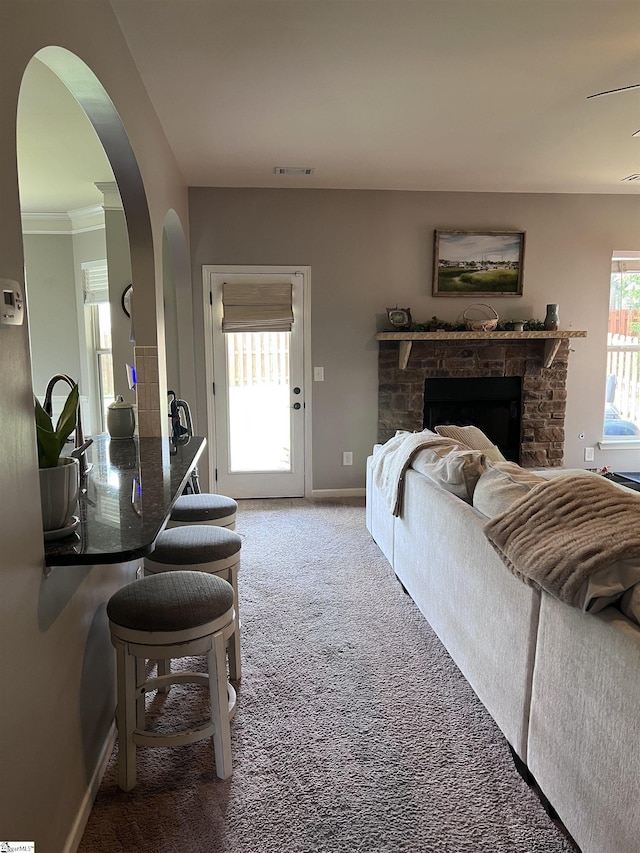 112 Cameron Creek Ln, Simpsonville, SC 29681 - carpeted living area with baseboards, a fireplace, and arched walkways