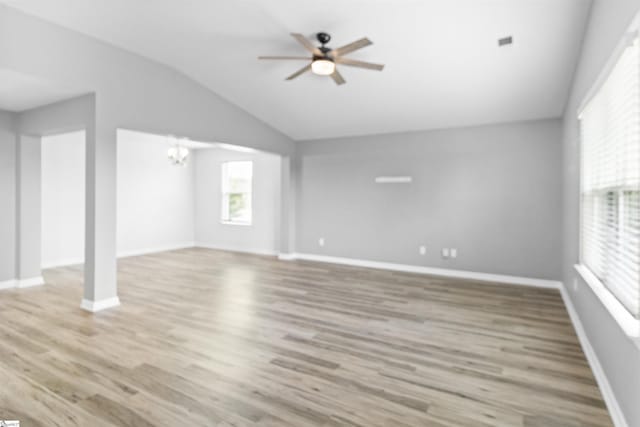 9023 Germaine Ct, Boiling Springs, SC 29316 - unfurnished living room featuring vaulted ceiling, ceiling fan, wood finished floors, a chandelier, and baseboards