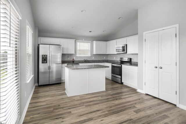 9023 Germaine Ct, Boiling Springs, SC 29316 - kitchen featuring appliances with stainless steel finishes, a sink, decorative backsplash, a center island, and white cabinets