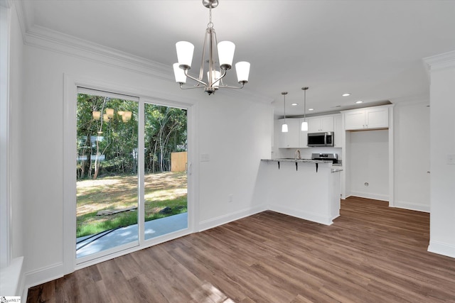 206 Daniels St, Anderson, SC 29625 - kitchen featuring stainless steel microwave, ornamental molding, white cabinetry, a chandelier, and dark wood-type flooring