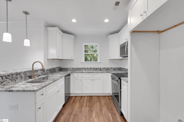 206 Daniels St, Anderson, SC 29625 - kitchen featuring stainless steel appliances, a sink, light stone counters, white cabinets, and light wood-type flooring
