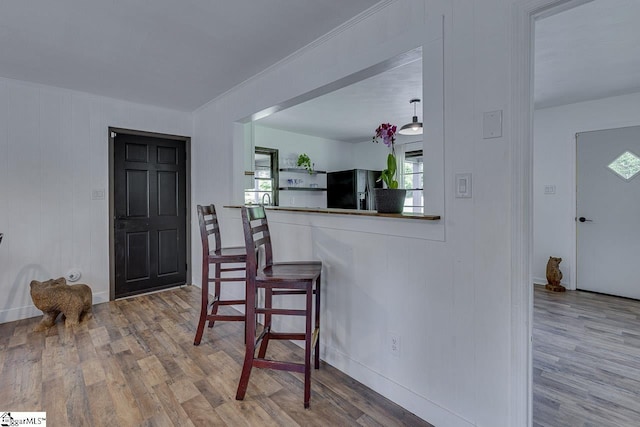 145 Rosewood Cir, Duncan, SC 29334 - kitchen with black fridge with ice dispenser, wood finished floors, and baseboards
