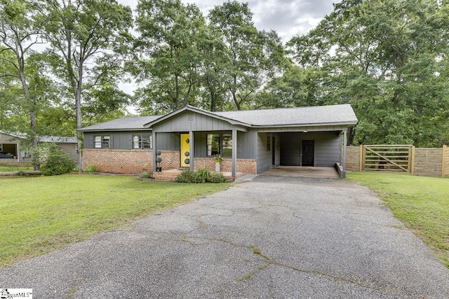 145 Rosewood Cir, Duncan, SC 29334 - view of front facade with driveway, an attached carport, brick siding, and a shingled roof