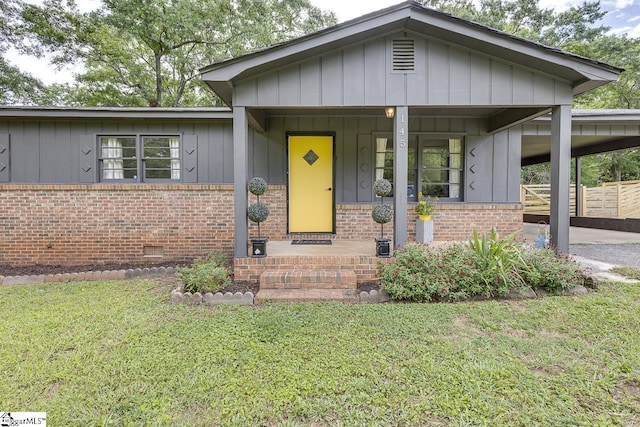 145 Rosewood Cir, Duncan, SC 29334 - view of front of property with brick siding, board and batten siding, an attached carport, and a front lawn
