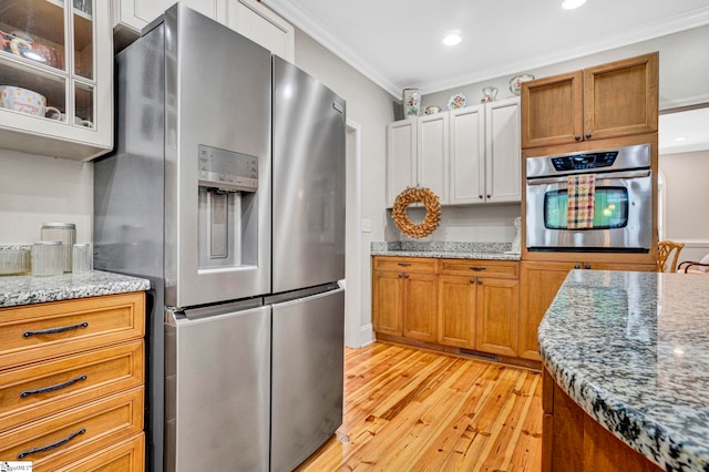 8 Knob Creek Ct, Greer, SC 29651 - kitchen featuring appliances with stainless steel finishes, light wood-style floors, crown molding, recessed lighting, and glass insert cabinets