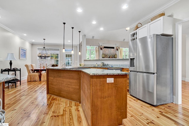 8 Knob Creek Ct, Greer, SC 29651 - kitchen with stainless steel fridge, light wood-style flooring, ornamental molding, light stone counters, and white cabinetry