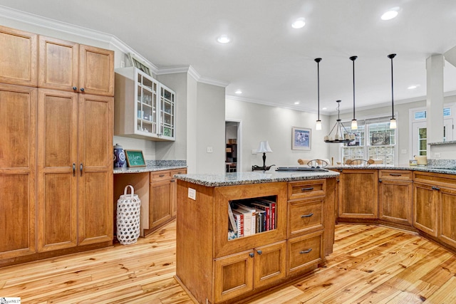 8 Knob Creek Ct, Greer, SC 29651 - kitchen with crown molding, light wood finished floors, brown cabinetry, glass insert cabinets, and light stone countertops